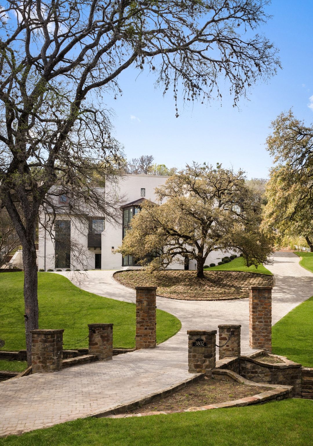 Aerial view of gated brick entry and circular drive
